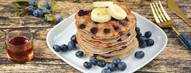 Plate with small pancakes with berries