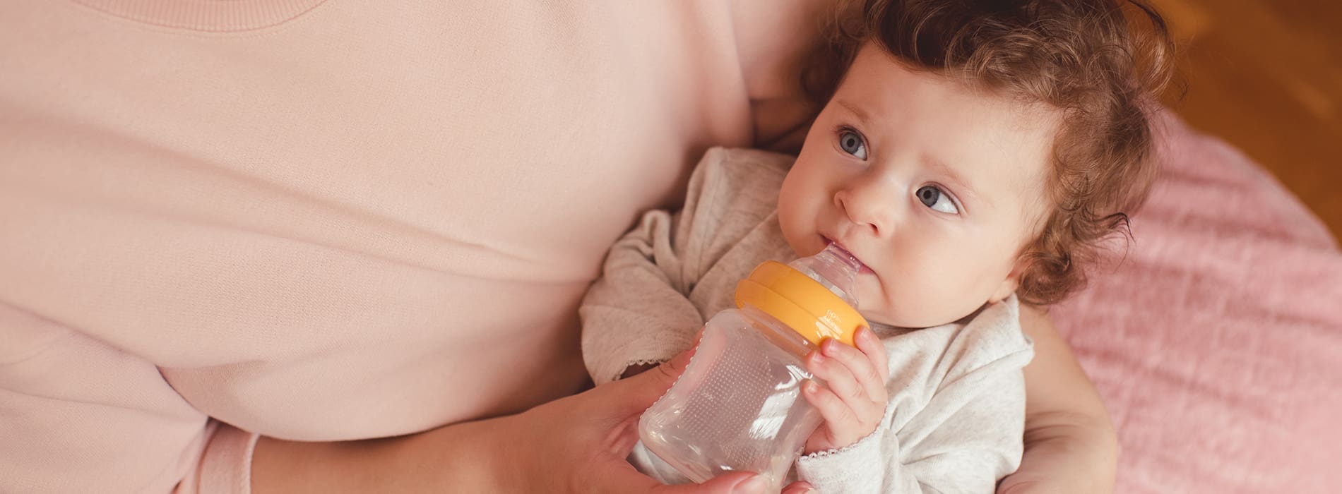 Mother bottle feeding her child